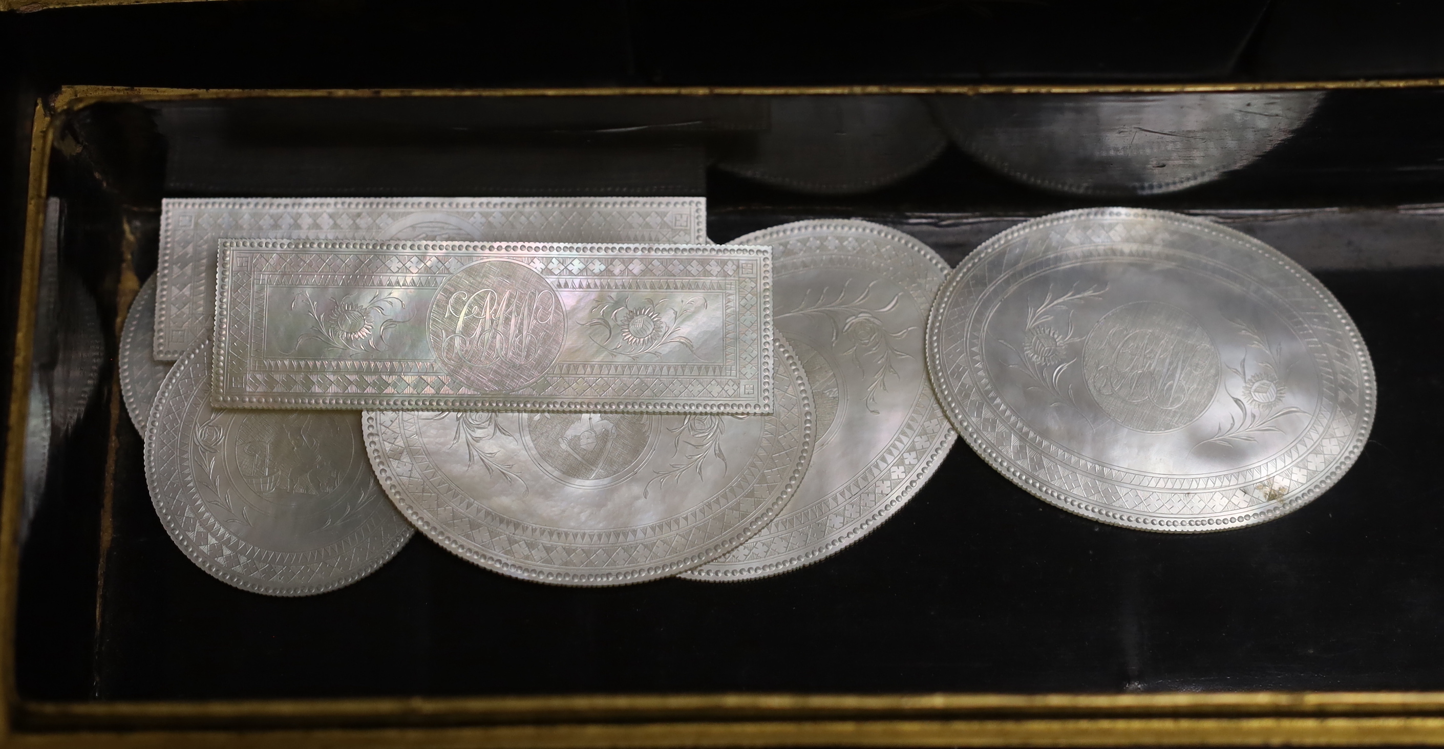 A 19th century Chinese export lacquer games box and mother of pearl counters